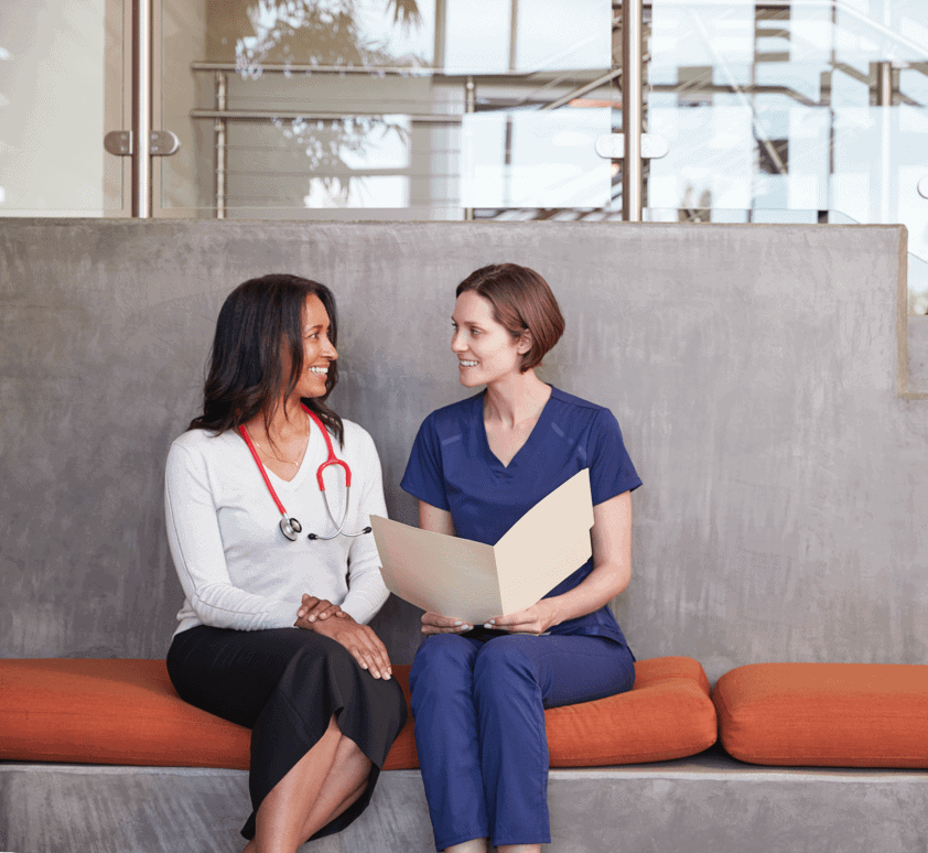 two-female-healthcare-workers-discussing-a-medical-SF9RJN8